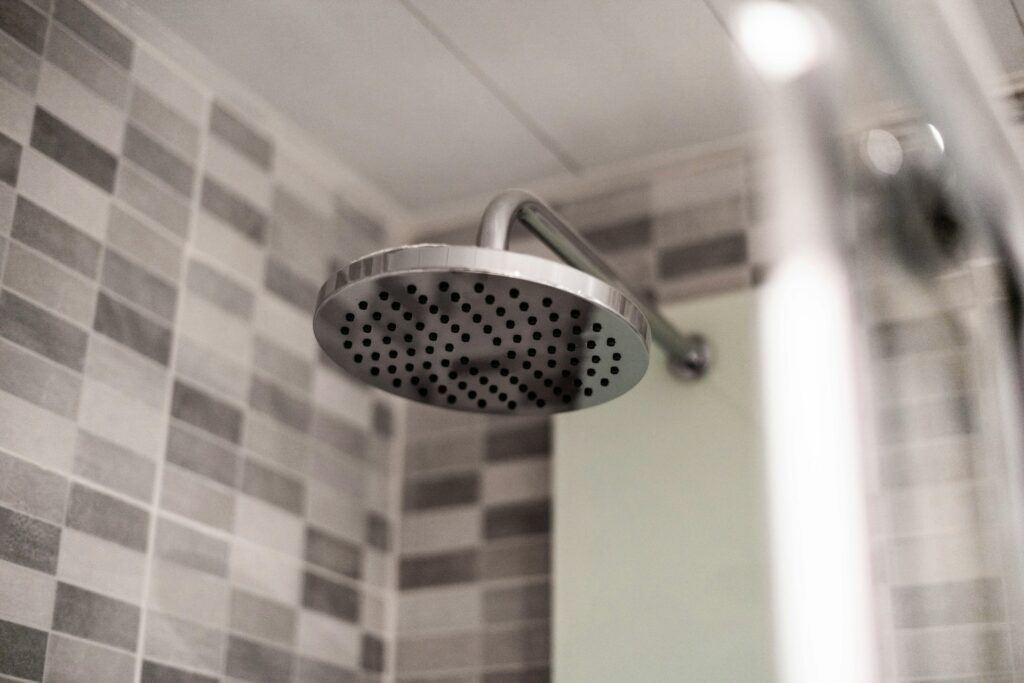 Water flowing gently through hair during post-transplant cleansing routine