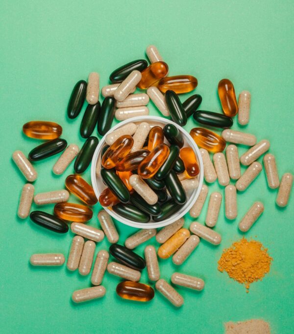 Hair health supplements and nutrient capsules representing ingredients that support reduced hair loss