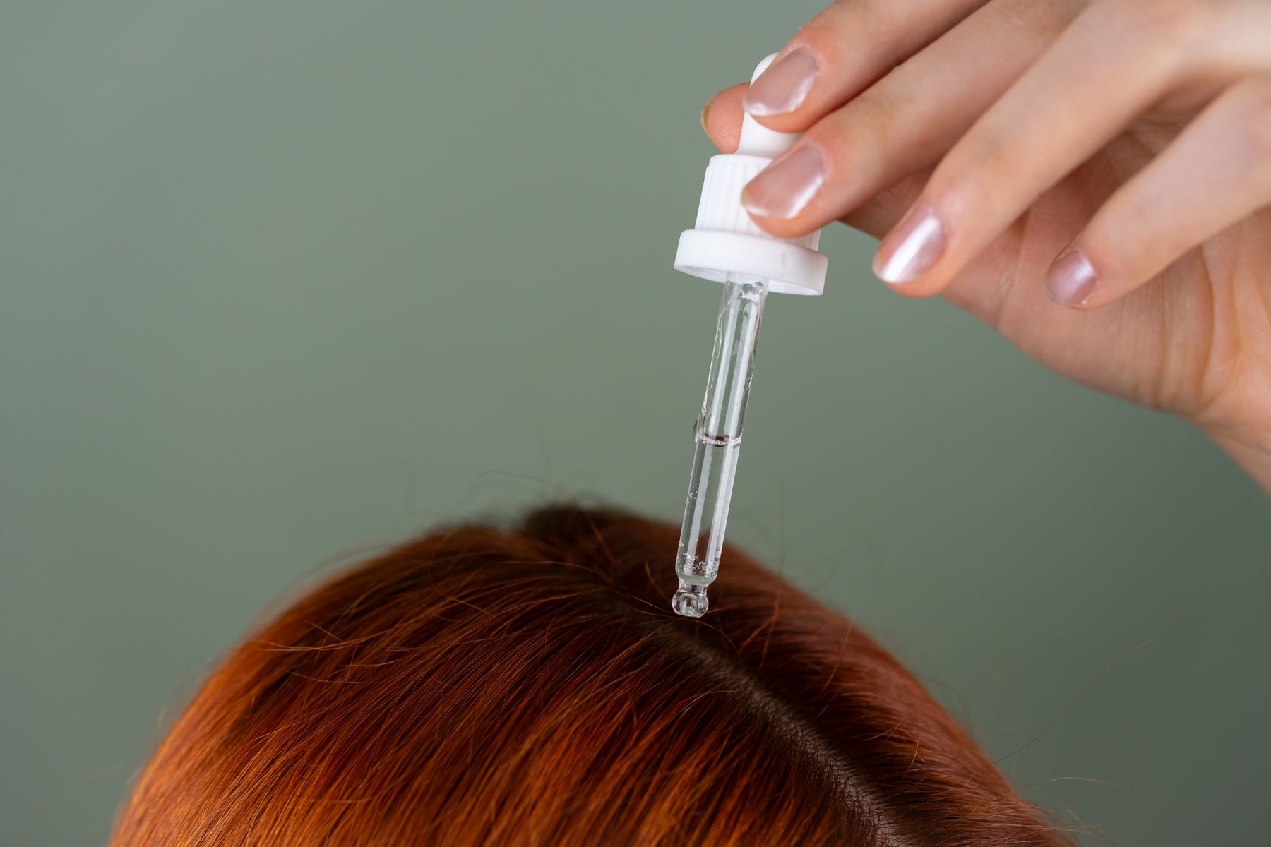 Applying hair serum to the scalp as part of post-transplant mesotherapy aftercare