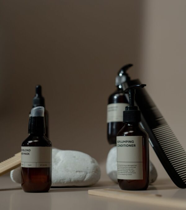 Hair care product bottles and a comb for a post-transplant product routine