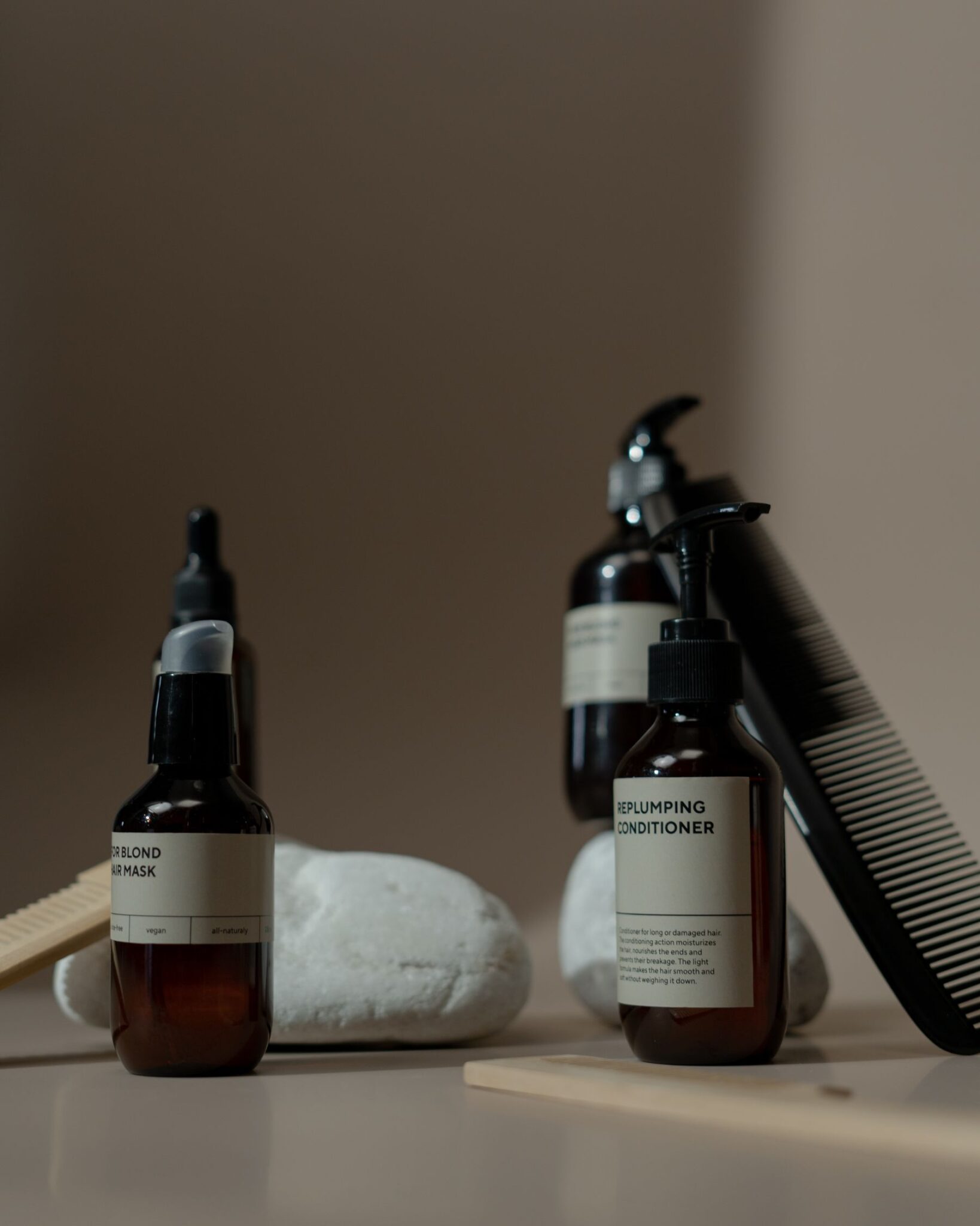 Hair care product bottles and a comb for a post-transplant product routine
